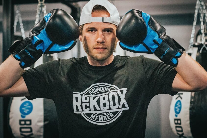 Rockbox franchise owner poses with boxing gloves